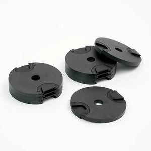 Four black plastic components on a white background