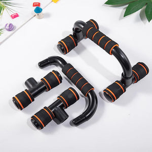 Black and orange exercise handles on a white background with green leaves.
