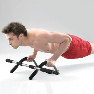 Man using a black and silver exercise device on a white background