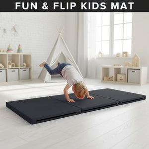Child playing on a black 'Fun & Flip Kids Mat' in a bright room with toys and furniture.