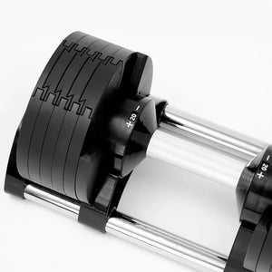 Close-up of a black and silver adjustable dumbbell on a white background