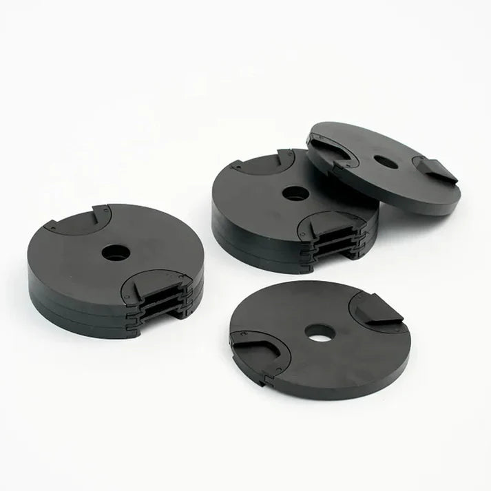Four black plastic components on a white background