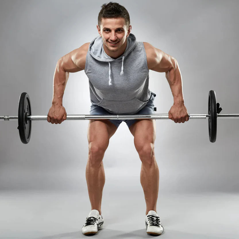 Man lifting a barbell on a gray background