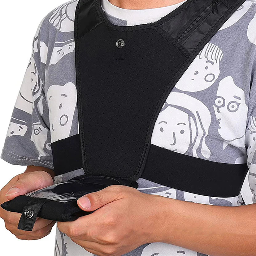 Person wearing a black shoulder brace over a patterned shirt