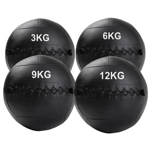 Four black weighted medicine balls with weight markings on a white background