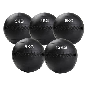 Set of five black weighted medicine balls with weight markings on a white background